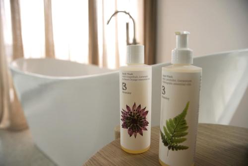 two bottles ofodorizers sitting on a table next to a sink at Stylish Villa, Rural Setting, Infinity Pool in Pano Akourdalia