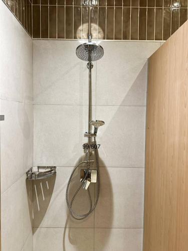 a shower in a bathroom with a light on the wall at Eden D condo reefB244 in Kathu