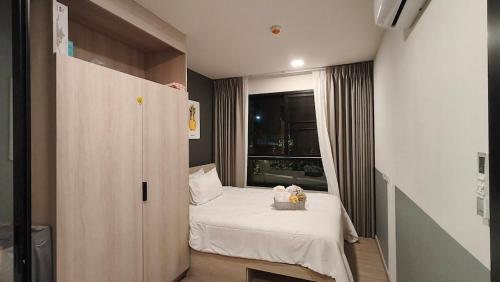 a small room with a bed and a window at Eden D condo reefB244 in Kathu