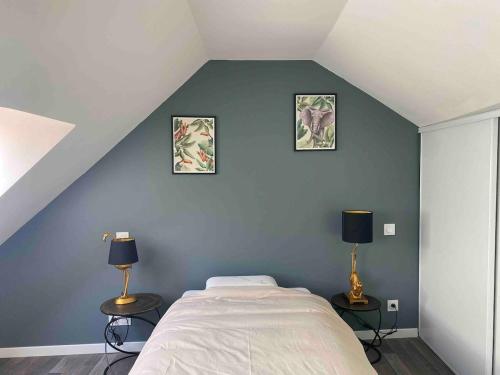 a bedroom with a bed and three pictures on the wall at La Stracciatella Saint-Aignan in Saint-Aignan
