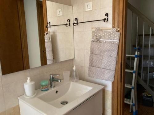 a bathroom with a sink and a mirror at Casa Selia in Cecina