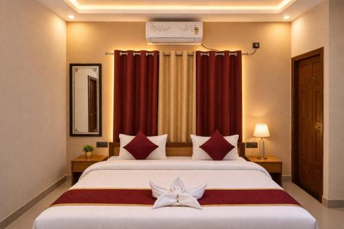 a bedroom with a large bed with a white flower on it at Pavitram Hotel & Banquet in Rānchī