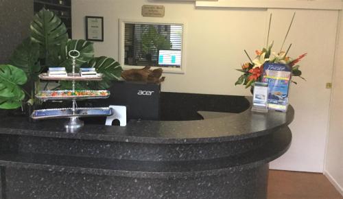a black counter with flowers on top of it at Sunseeker Motel in Hervey Bay