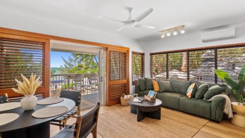 a living room with a couch and a table at Absolute Beachfront Palm Cove Apt Sleeps 4 in Palm Cove