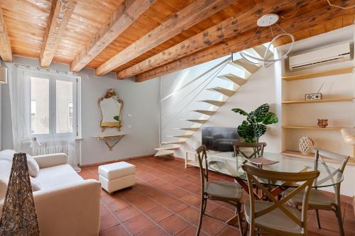 a living room with a staircase and a table and chairs at Truly Verona in Verona