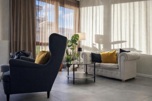 a living room with two chairs and a table at Hotiday Firenze Vespucci in Florence