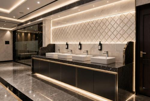 a bathroom with three sinks and a large mirror at Pavitram Hotel & Banquet in Rānchī