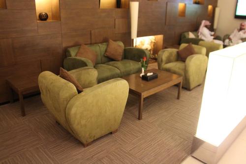 a living room with a couch and a coffee table at Executives Hotel - Olaya in Riyadh
