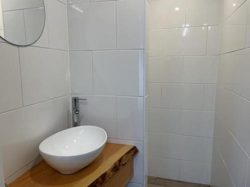 a bathroom with a white sink and a mirror at Duintentje in Schiermonnikoog