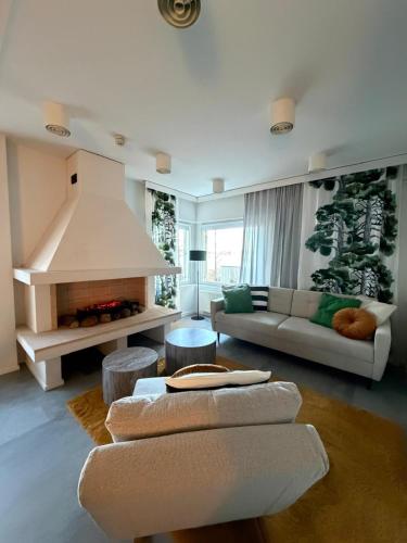 a living room with a couch and a fireplace at Meri-Karina in Turku