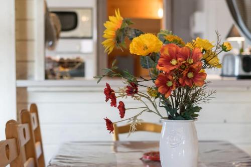 a vase filled with flowers sitting on a table at Les Clarines in Mouthe