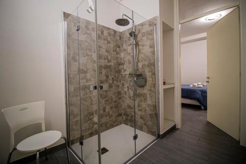 a bathroom with a shower with a table and a stool at Casa Peppina in Gubbio