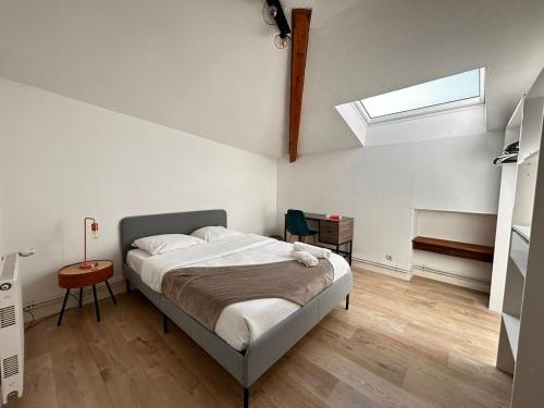 a bedroom with a bed and a skylight at Maison Duplex Collection, in Limoges