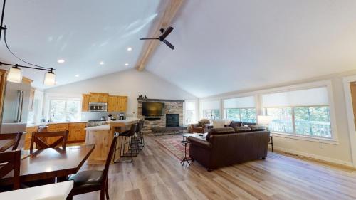 a kitchen and living room with a couch and a table at 1 Fifteenth Tee Lane in Sunriver