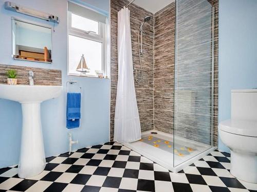 a bathroom with a shower with a toilet and a sink at 4 Bed in Wigton oc-sz384 in Bothel