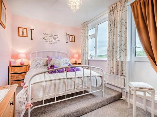 a bedroom with a white bed and a window at 4 Bed in Wigton oc-sz384 in Bothel