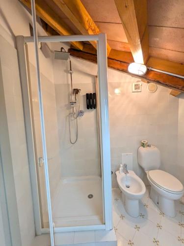 a bathroom with a shower and a toilet and a sink at Al Castello B&B in Eboli
