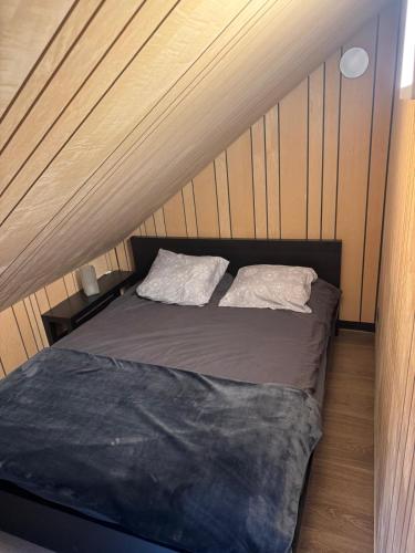 a bed with two pillows on it in a room at ARD'n aise in Stoumont