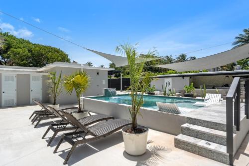 a patio with chairs and a swimming pool at La Balandra Luxury Stays in Dorado