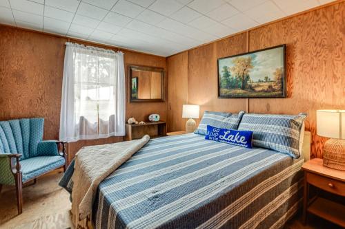 a bedroom with a bed and a chair and a window at Steps to St Albans Bay! Basecamp w/ Grill in Saint Albans Bay