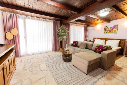 a living room with a couch and a table at BELAIR Rooms Montenegro in Sutorina