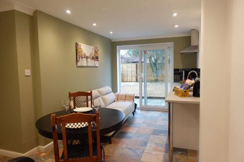 a living room with a couch and a table at Modern Bicester Studio Self-Contained with Parking in Bicester