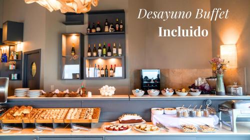 a restaurant with a buffet of food and drinks at Edenia Hotel & Nature in El Calafate