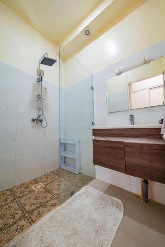 a bathroom with a glass shower and a sink at Loft Beachfront Bungalow with Private Beach in Dakhla