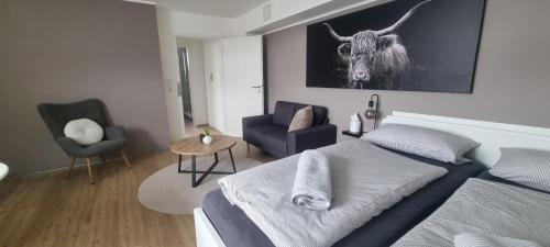 a bedroom with a bed with a bull on the wall at Wohlfühlen in Hohberg in Hohberg