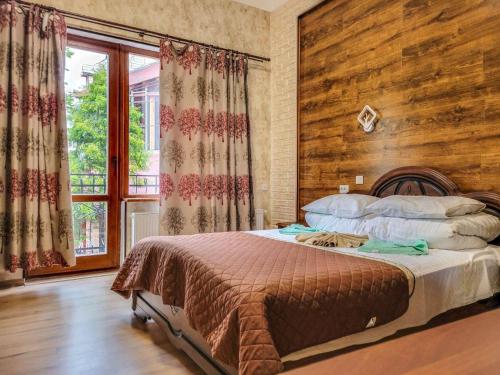 a bedroom with a bed with a wooden wall at Glory Apart Hotel in Truskavets