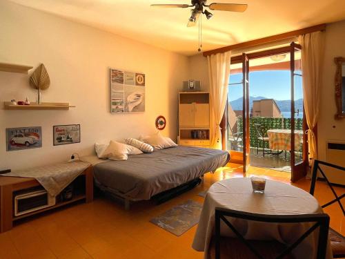 a bedroom with a large bed and a balcony at Appartamento Pascià al Lago in Oggebio