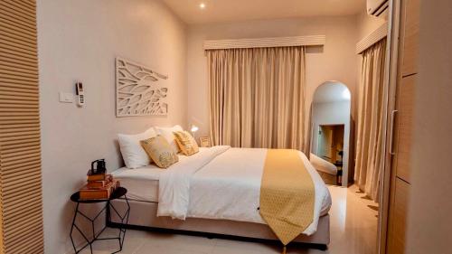 a bedroom with a large bed in a room at Tulum Villa Resort Koh Samui in Bophut