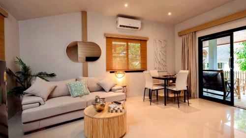 a living room with a couch and a table at Tulum Villa Resort Koh Samui in Bophut