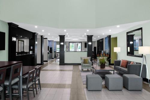 a lobby of a hotel with chairs and a bar at Best Western Plus Miami-Doral/Dolphin Mall in Miami