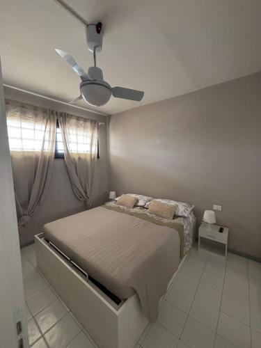 a bedroom with a bed and a ceiling fan at La casa di Giorè - Fronte Mare Gabbiani Ombrellone e 2 lettini inclusi in Fano