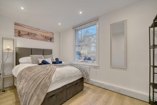 a bedroom with a large bed and a window at The Cozy Quarter in Bromley