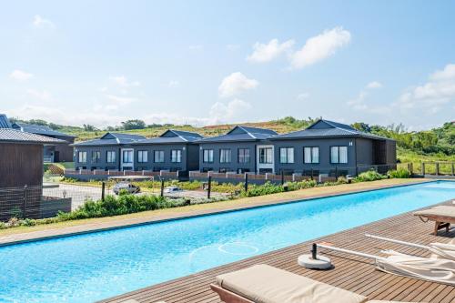 a villa with a swimming pool in a resort at Vista Zimbali in Ballito
