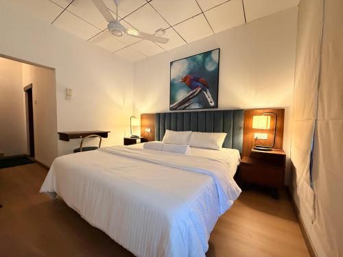 a bedroom with a large white bed in a room at Mount Crest Inn Deniyaya in Deniyaya
