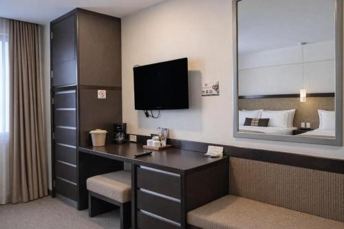 a hotel room with a desk and a tv at Hotel Catedral in Mexico City