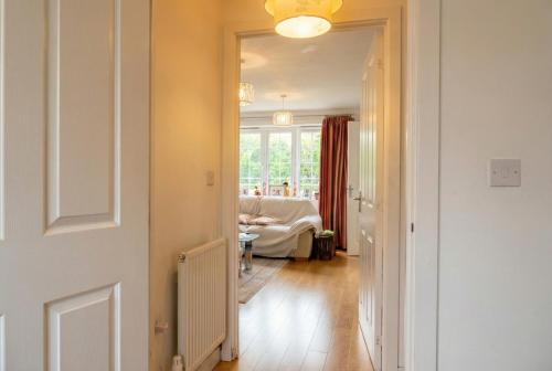 a hallway with a door leading to a living room at Quiet Three-Bedroom Home in Stewartby with Ensuite and Workspace in Bedford