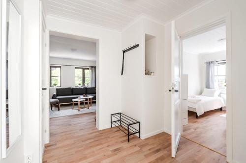 a white apartment with a hallway and a living room at Linneby in Uddevalla