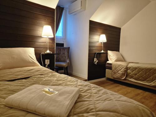 a hotel room with a bed and a chair at Järnvägshotellet Charlottenberg in Charlottenberg
