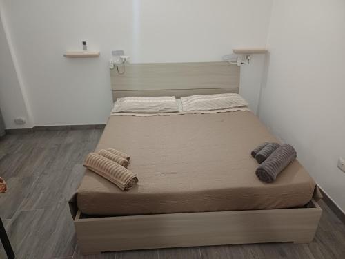 a bed in a room with two pillows on it at Casa vacanza Monoboito in Quartu SantʼElena