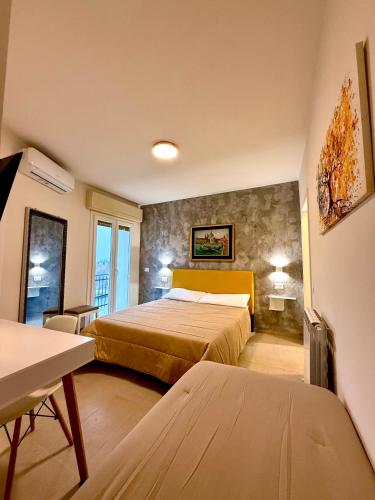 a hotel room with a bed and a table at B&B Il GLICINE - Uso Cucina e Parcheggio Privato in Sassuolo