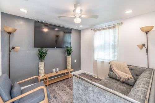 a living room with a couch and a tv at Noel Real Estate in Naples