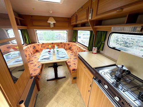 a kitchen with a table in the back of a rv at Camping im Lammgarten in Volkach