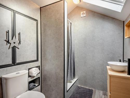 a bathroom with a toilet and a sink at 1 Bed in Maryport oc-96373 in Dearham