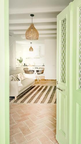 a living room with a couch and a bed in a room at Casa do Mar - Casas do Levante in Olhão