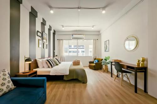a bedroom with a bed and a desk in a room at Industrial Loft Sukhumvit 3-Bedroom Designer House - 2 Min to BTS Bang Chak in Bangkok