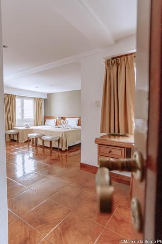 a large bedroom with a bed and a table at Ortegal Urban Suites in Mar del Plata